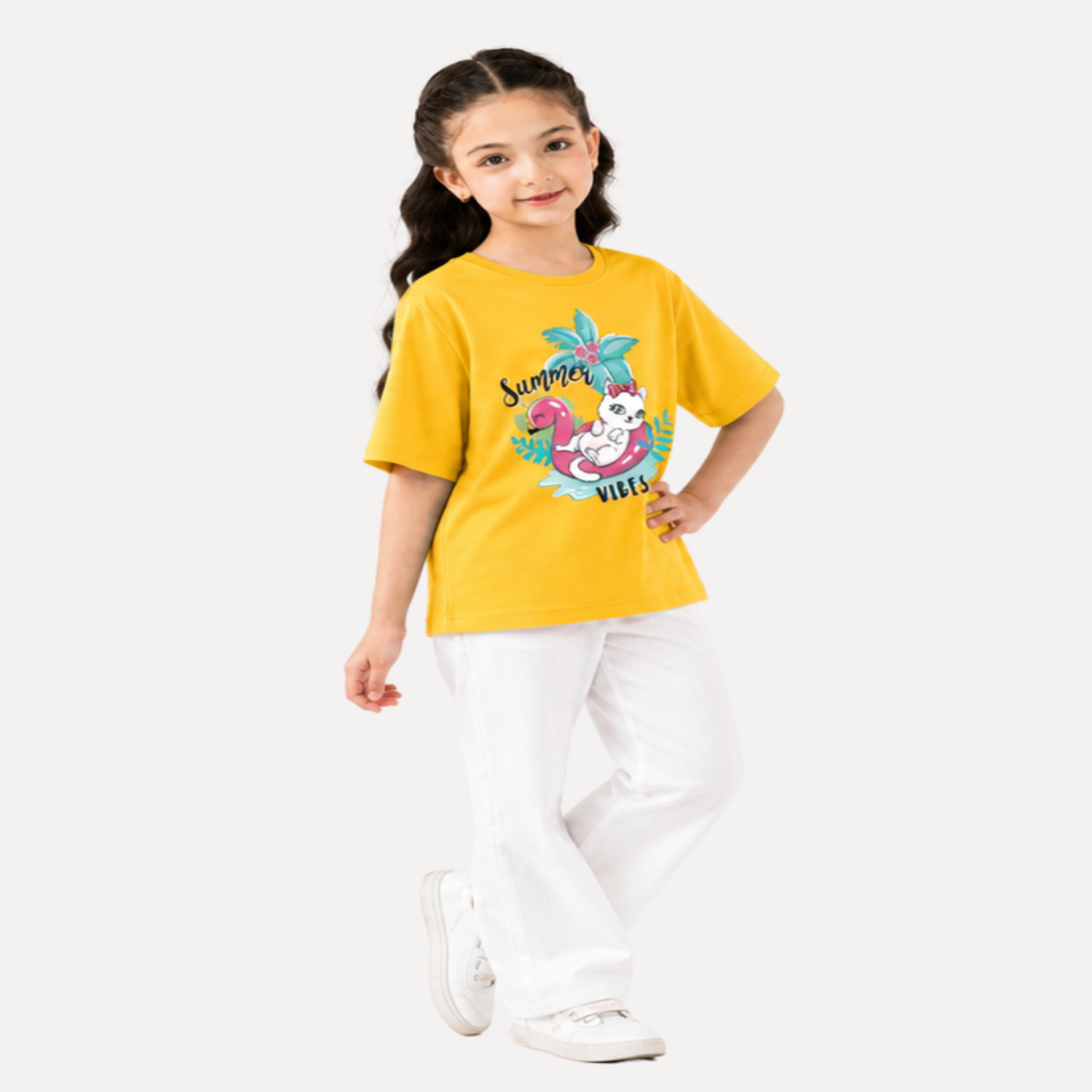 Young girl wearing a yellow t-shirt with a colorful graphic design on a white background